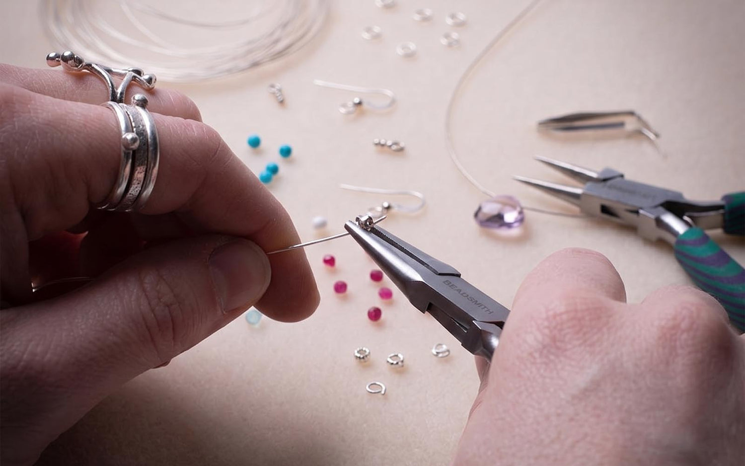 A collection of essential jewelry repair tools and supplies including pliers, adhesives, and findings for fixing broken jewellery at home.
