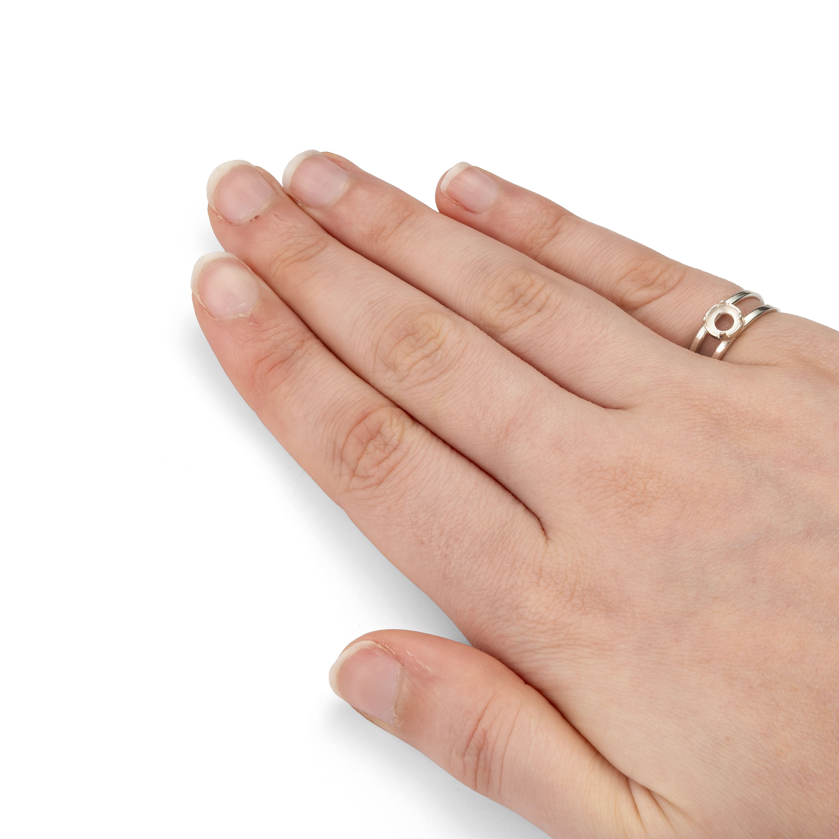 Hand wearing a silver ring on a white background