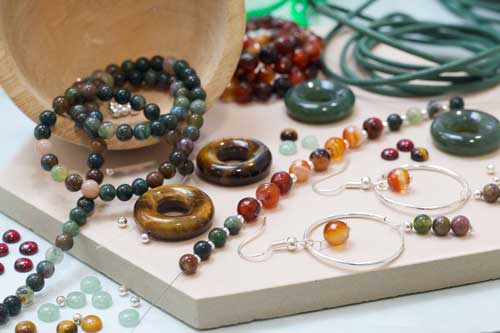 Earth Jewellery Business Starter Kit collection with green, brown and natural-toned gemstones