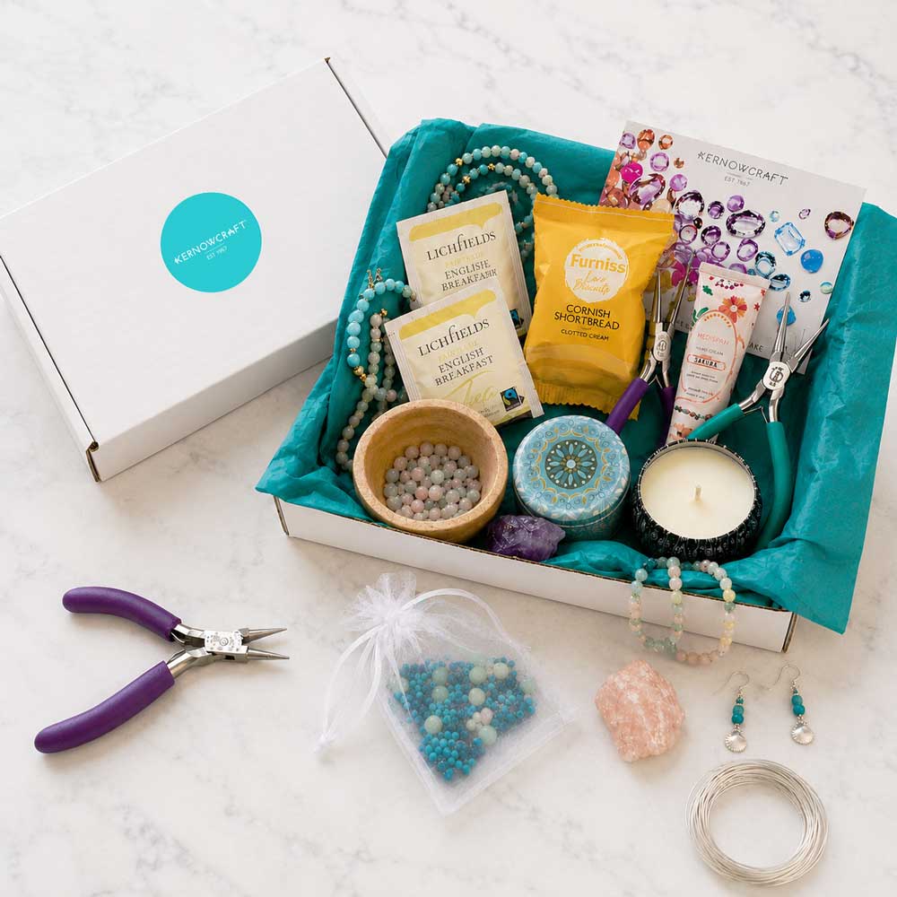 Jewellery making subscription box showing project materials, jewellery tools, gemstones, beads, self-care treats and inspiration booklet from Kernowcraft.
